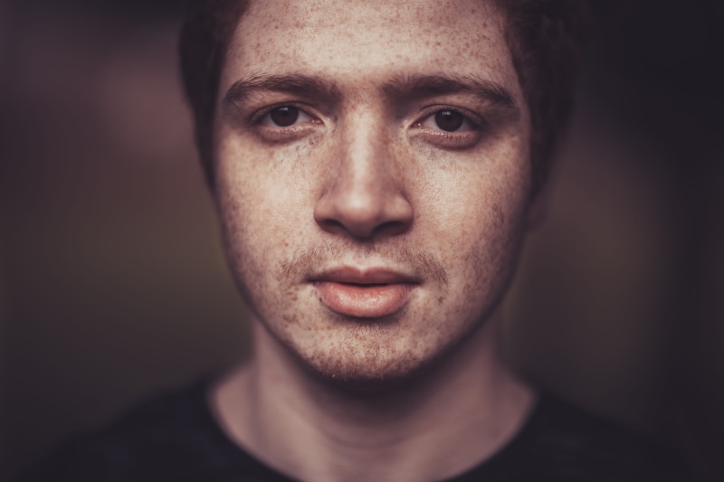guy, head, indoors, human head, 5K, eyes, freckles, serious, person, model, portrait, adult, man, studio, human face, facial expression, contrast, body part