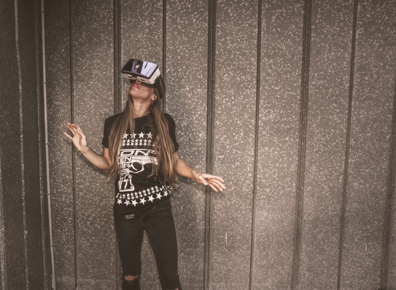glasses, leisure activity, indoors, real people, person, standing, three quarter length, women, female, technology, young adult, brunette, virtual reality headset