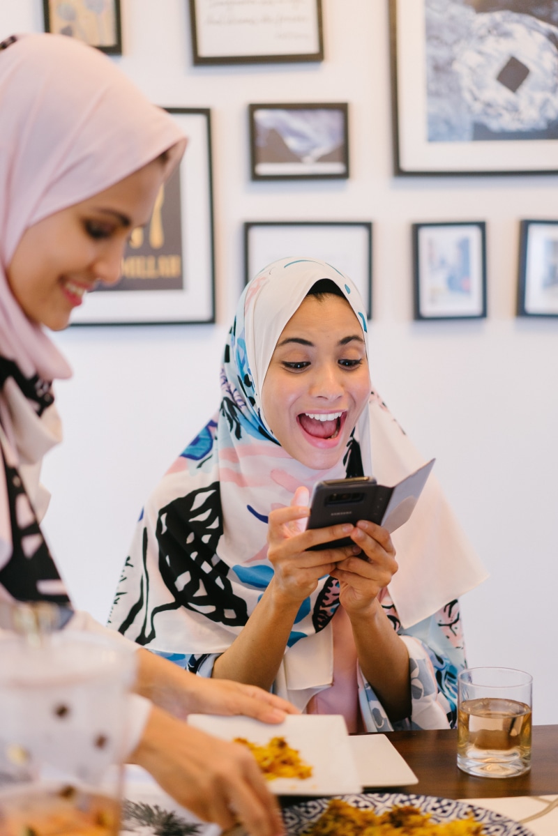 technology, togetherness, lifestyles, holding, pretty, food, women, adult, family, wear, happiness, indoors, wireless technology, looking, headshot, sitting