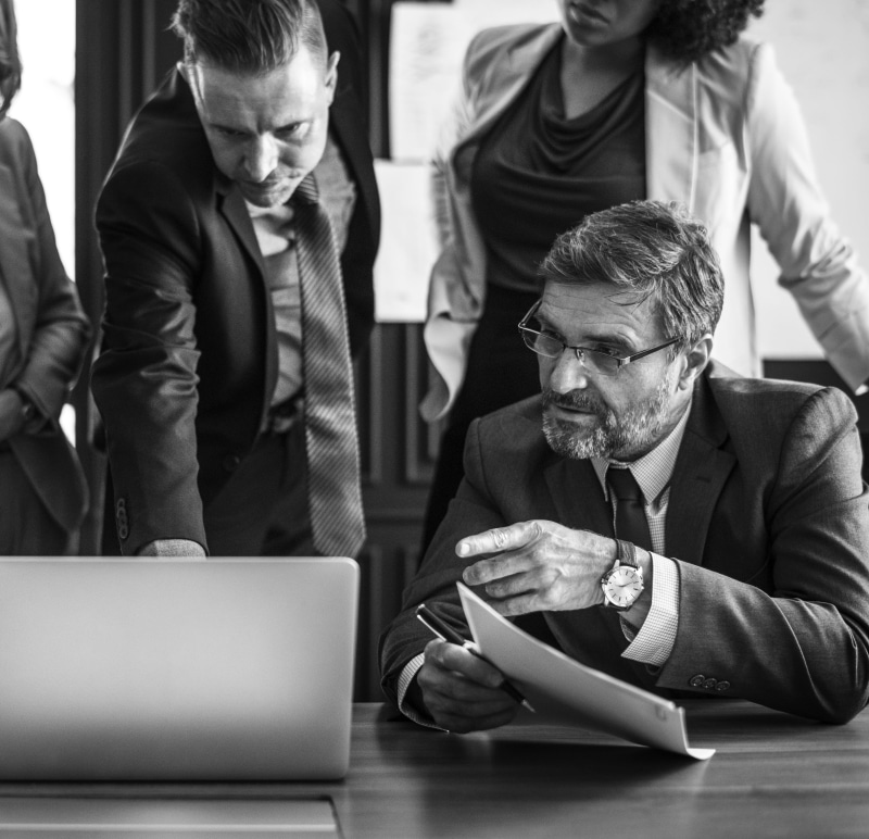 businesswear, opened, grayscale, digital device, office, computer, sitting, workplace, meeting, using laptop, 2K, mature men, teamwork, businessman, colleagues