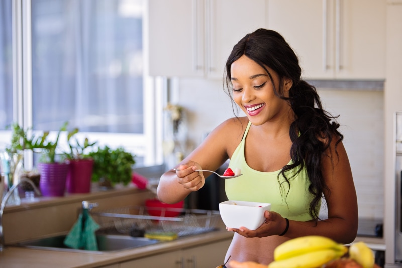adult, one person, lifestyles, young adult, fitness model, white, happiness, healthy, bowl, 5K, strawberry, food, enjoyment, domestic kitchen, home, girl