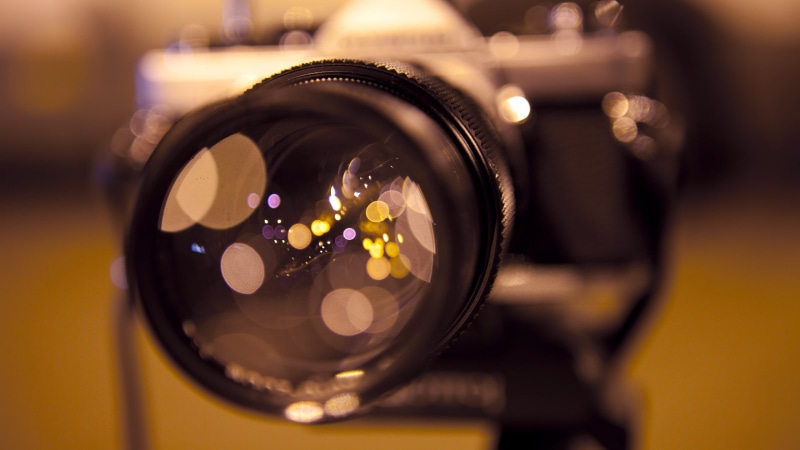 circle, indoors, alcohol, bokeh, no people, illuminated, macro, food and drink, camera - photographic equipment, yellow, close-up, selective focus, technology