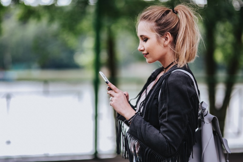 smart phone, holding, handrail, technology, lifestyles, green, ripped, casual Clothing, people, text Messaging, woman, 4K, wireless Technology, side view