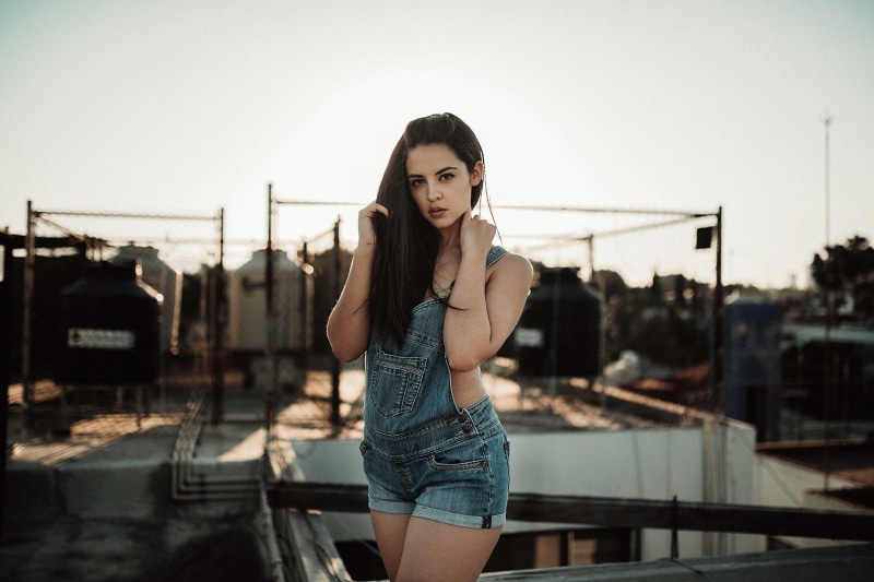 young women, casual clothing, women, standing, lifestyles, women outdoors, architecture, portrait, overalls, adult, brunette, fashion, beautiful people