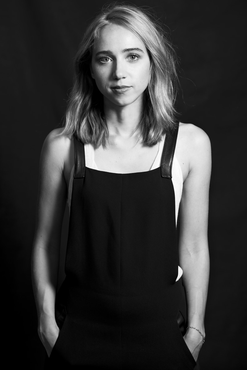 overalls, tank top, studio shot, fashion, beautiful woman, indoors, actress, black background, front view, standing, young adult, monochrome, looking at camera