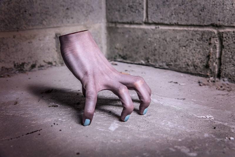 architecture, objects, side view, photo, human body part, concrete, whimsical, right, gray, human limb, right hand, halloween, haunted, day, weird, wall