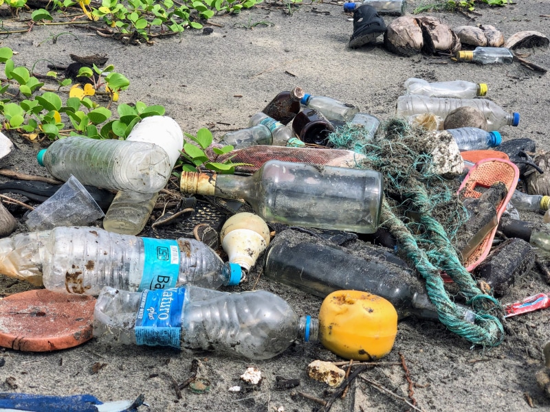 junkyard, garbage dump, plastic bag, plastic, sandy, assorted, disregard, bottle, water jug, day, environment, messy, surface, high angle view, hopelessness