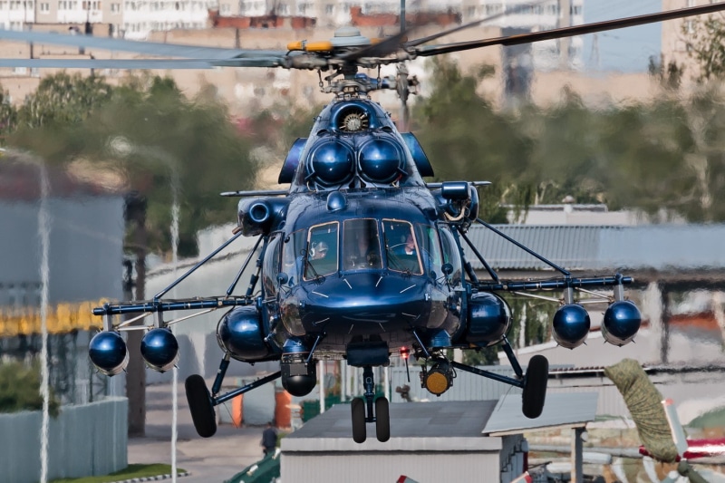 transportation, helicopters, motion, no people, built structure, Mi-8, building exterior, focus on foreground, air vehicle, aerospace industry, travel