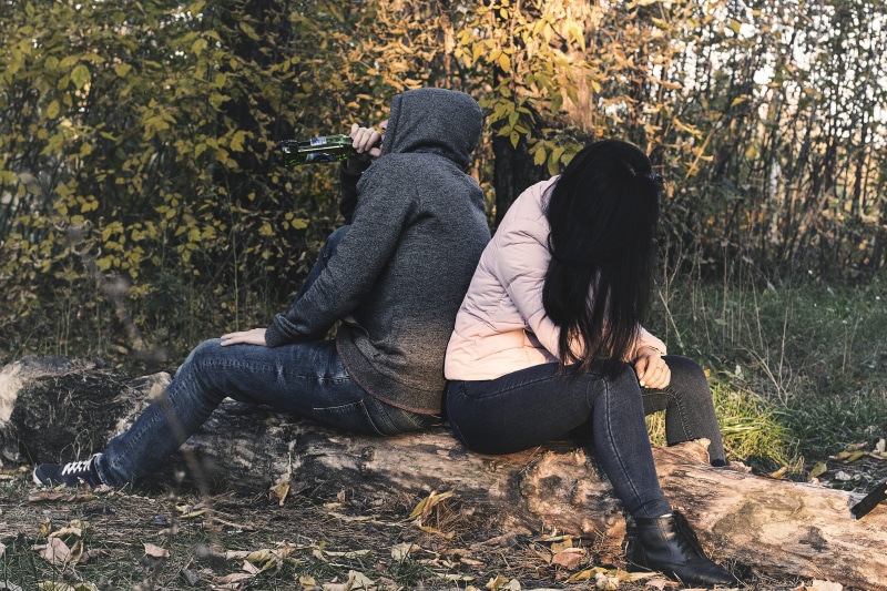 relationship, conflict, full length, intoxication, casual clothing, alcoholism, man, drunk, men, on the log, beer, girl, tiff, young adult, positive emotion