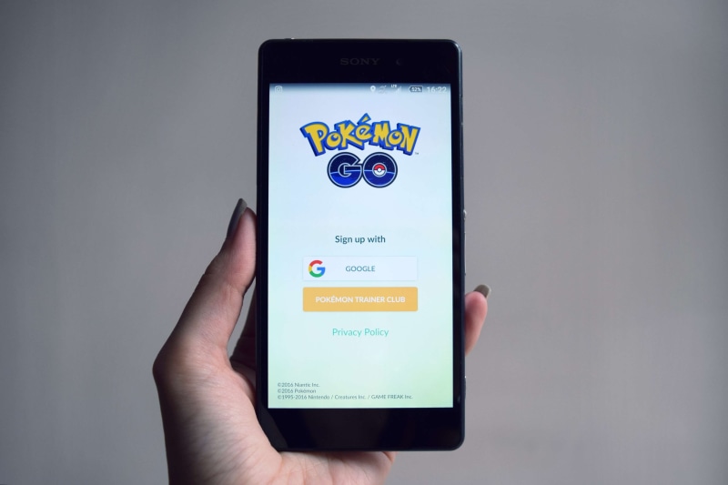 text, gps, player, mobile app, connection, one person, touch screen, digital tablet, smartphone, online, studio shot, device screen, hand, pokemon, mobile