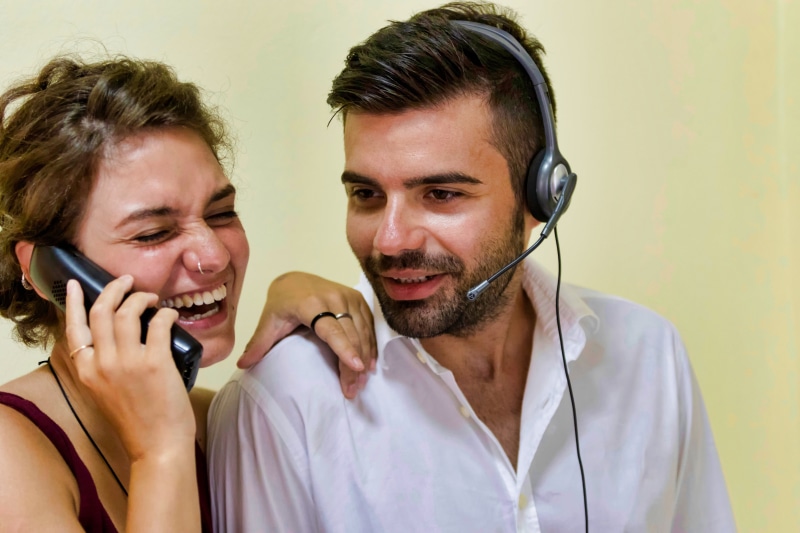positive emotion, near, communication, headset, indoors, headshot, connection, adult, call center, two people, telephone, man, work, listening, smiling