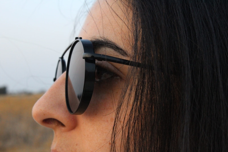 5K, body part, profile view, sunglasses, technology, listening, glasses, headshot, close-up, focus on foreground, looking, hands-free device, portrait