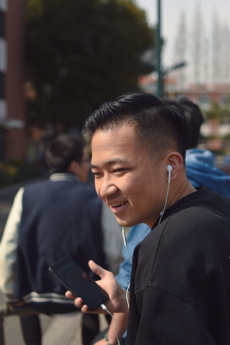 business, outdoors, portrait, overcoat, computer, person, holding, incidental people, young men, people, pedestrian, one person, headset, men, lifestyles