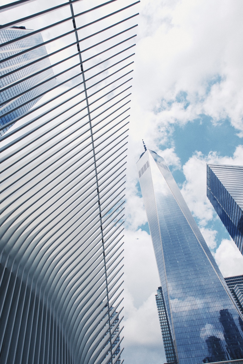 low angle view, tall - high, day, city, glass - material, sunlight, reflection, cloud - sky, outdoors, new york, nyc, modern, 4K, skyscraper, office, glass