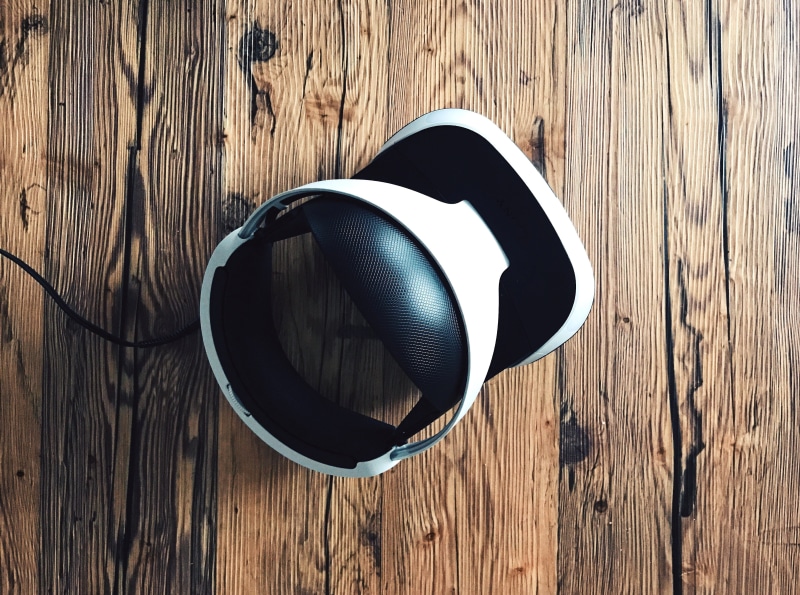 gaming, close-up, fun, two objects, table, headphones, ps, technology, black, wooden floor, wood - material, wood, personal accessory, sunlight, indoors