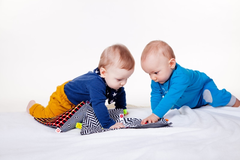 booklet, books for kids, looking, two, children, young, bed, males, playing, child, baby, two people, innocence, togetherness, full length, men, toy, boys