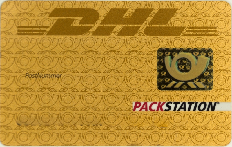 identification, pin, access, studio shot, close-up, gold, western script, design, post, backgrounds, yellow, pack station, dhl, text, indoors