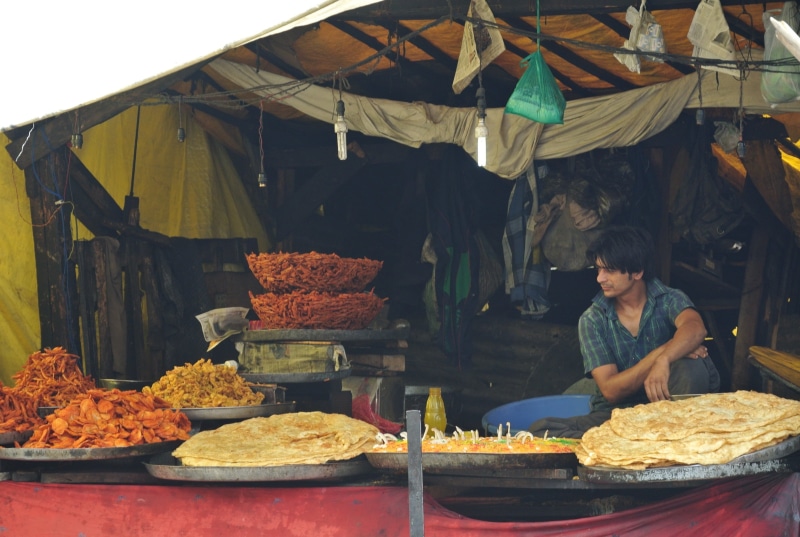2K, outdoors, one person, women, kashmir, market, food and drink, indian market, retail display, food, small business, casual clothing, day, for sale