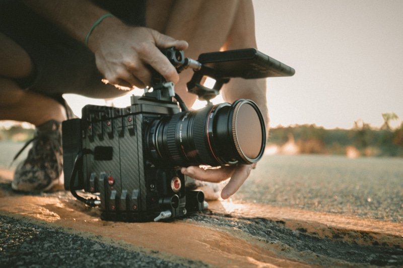close-up, camera - photographic equipment, transportation, focus on foreground, one person, path, wheel, filming, focus, asphalt, using, multimedia, professional