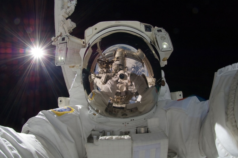 helmet, cockpit, floating, low angle view, job, tools, one person, technology, adult, visor, maintenance, space exploration, space, working, science, pack