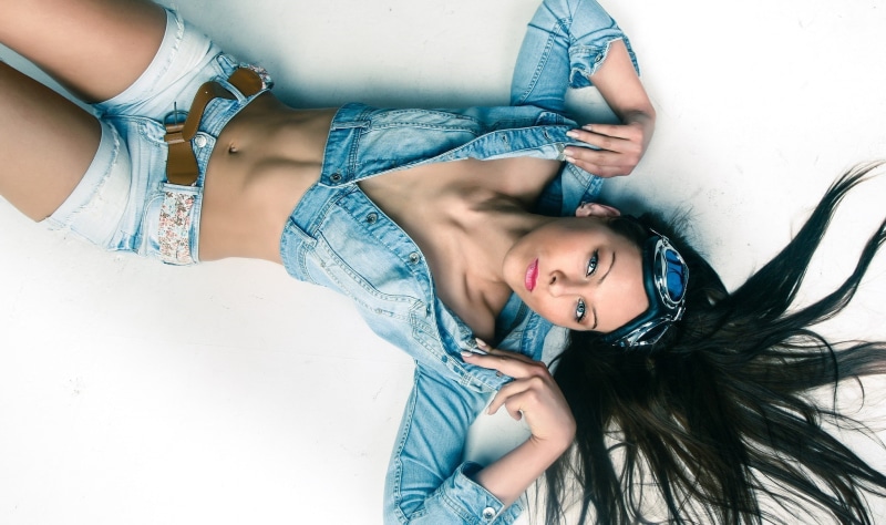 lying on back, hairstyle, leisure activity, cyan, casual clothing, black hair, portrait, young adult, real people, jeans, front view, beautiful woman, females