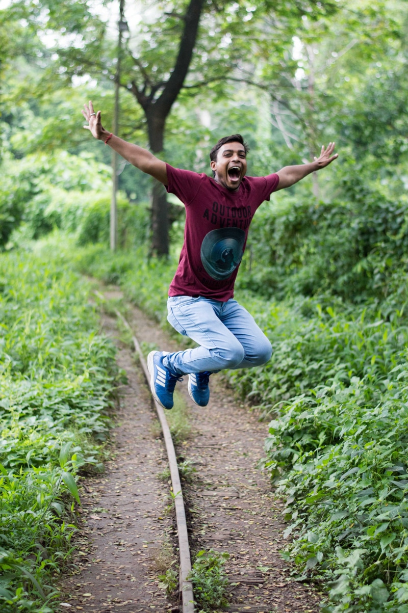 wear, jump shot, growth, lifestyles, human body part, summer, positive emotion, fun, front view, action, jumping, grass, man, daylight, enjoyment, leisure activity