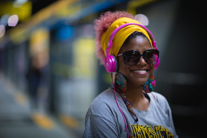 electronics, focus on foreground, portrait, glasses, smile, fearless, toothy smile, colorful, woman, unique, person, women, casual clothing, face, headset