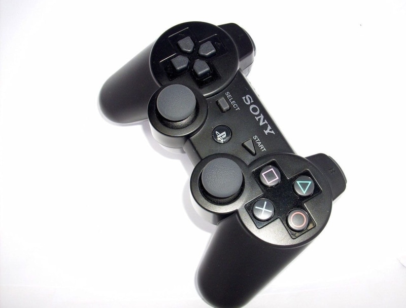 copy space, black, indoors, computer, studio shot, telecommunications equipment, arts culture and entertainment, dualshock, white background, still life