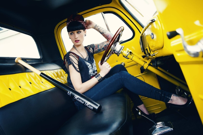 motor vehicle, casual clothing, fashion, one person, yellow, women with cars, 1080P, beautiful woman, leisure activity, sitting, real people, car interior