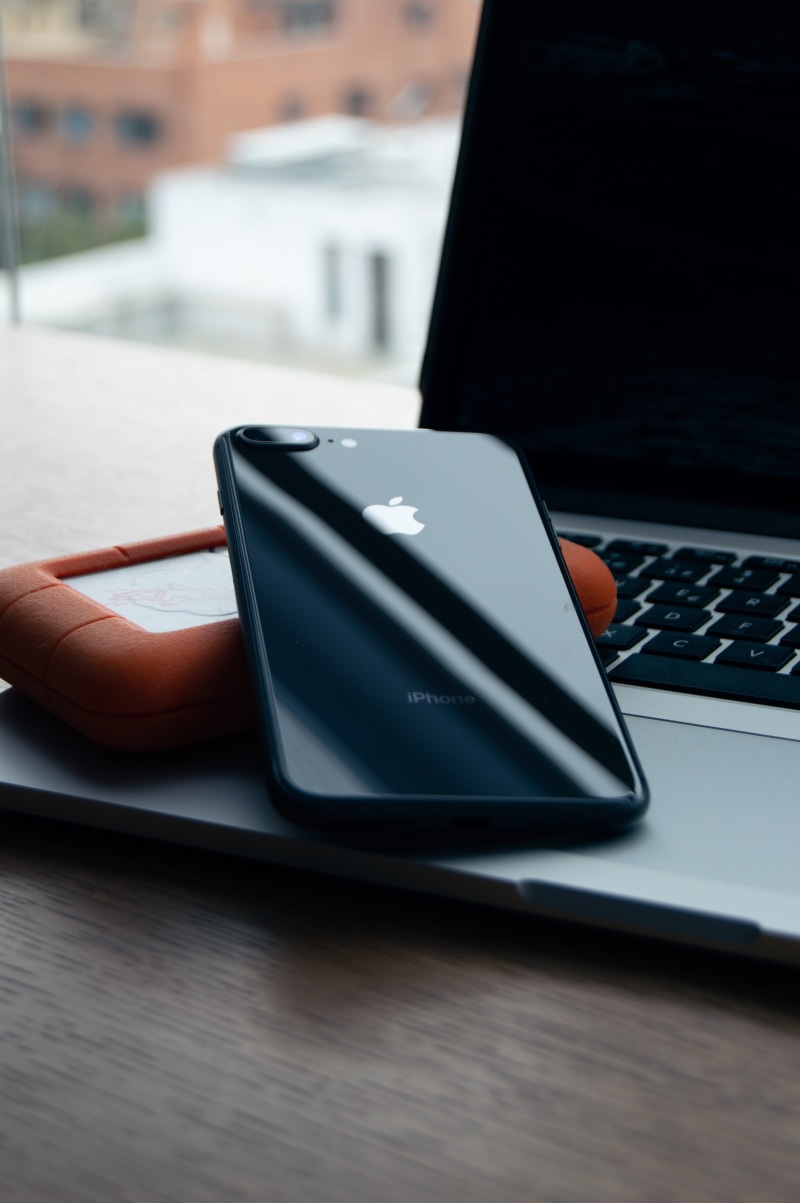 human hand, case, gray, one person, macbook, computer, computer equipment, iphone, laptop, communication, space, table, mobile, body part, human body part