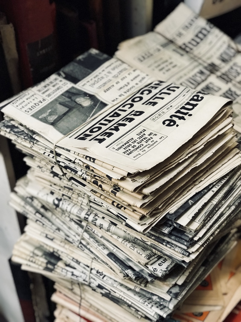 ephemera, read, paper, variation, finance, paris, no people, musical note, politics, text, day, shift, indoors, high angle view, news, lot, tilt, still life