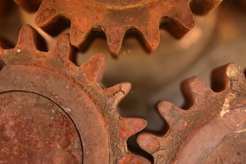 dirt, wheel, industrial equipment, pattern, running smoothly, rusted, gears, no people, machinery, metal industry, machine part, symbolism, mechanics, manufacturing equipment