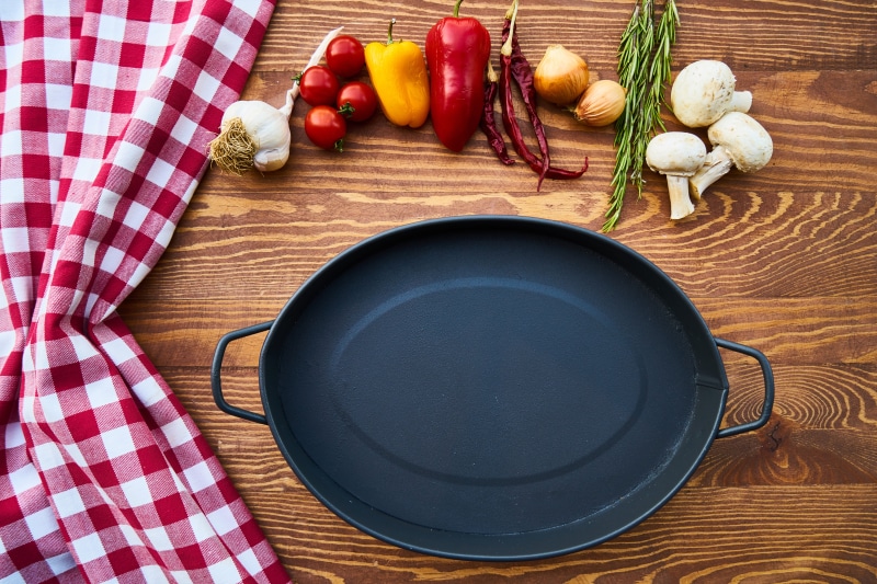 restaurant, no people, cook, wooden, herb, iron, vegetable, wood - material, tablecloth, directly above, skillet, preparing food, cutting board, garlic