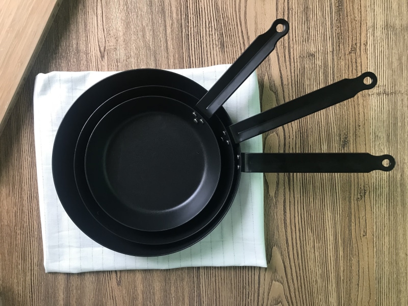 refreshment, cup, black color, care, circle, cast iron pot, carbon steel pan, tray, cooking, crockery, kitchen utensil, wood - material, table, close-up