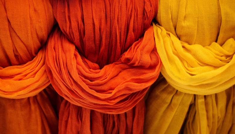 large group of objects, vibrant, cotton, orange color, close-up, backgrounds, textile, red, clothing, laundry, drape, orange, cloth, yellow, crease, indoors