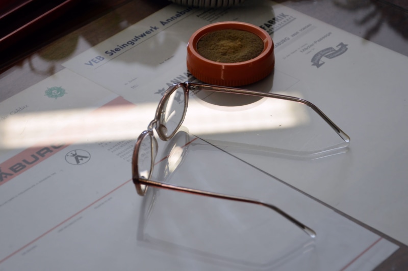 high angle view, east germany, glass - material, still life, indoors, workplace, personal accessory, day, old, communication, food and drink, Glasses, document