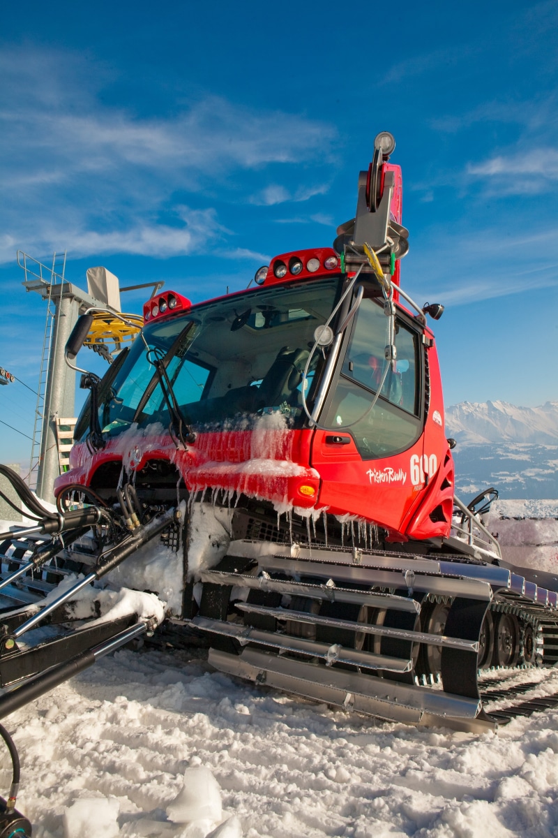 cold temperature, no people, snow, land vehicle, transportation, day, occupation, outdoors, sunlight, safety, runway maintenance vehicles, red, air vehicle