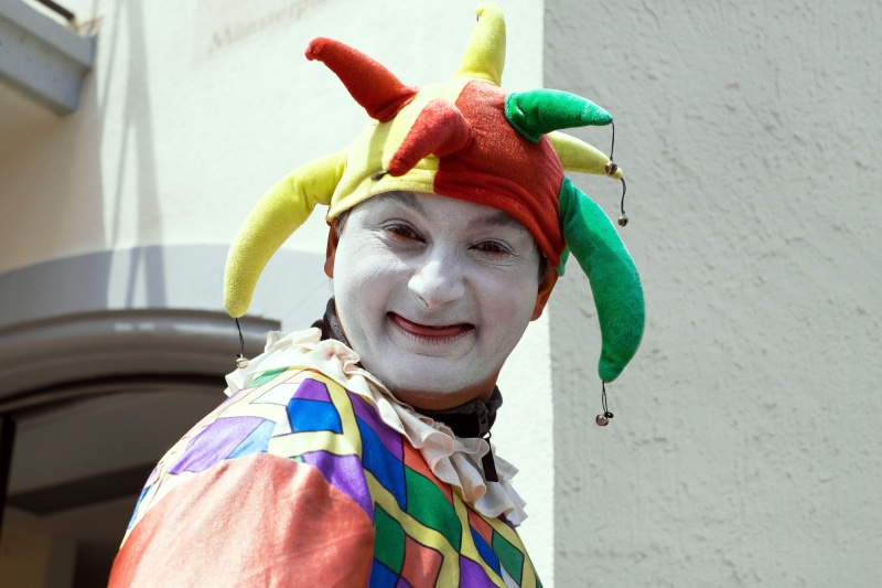 real people, court jester, person, clothing, near, clown, front view, day, people, leisure activity, outdoors, cultures, smiling, happiness, emotion, women
