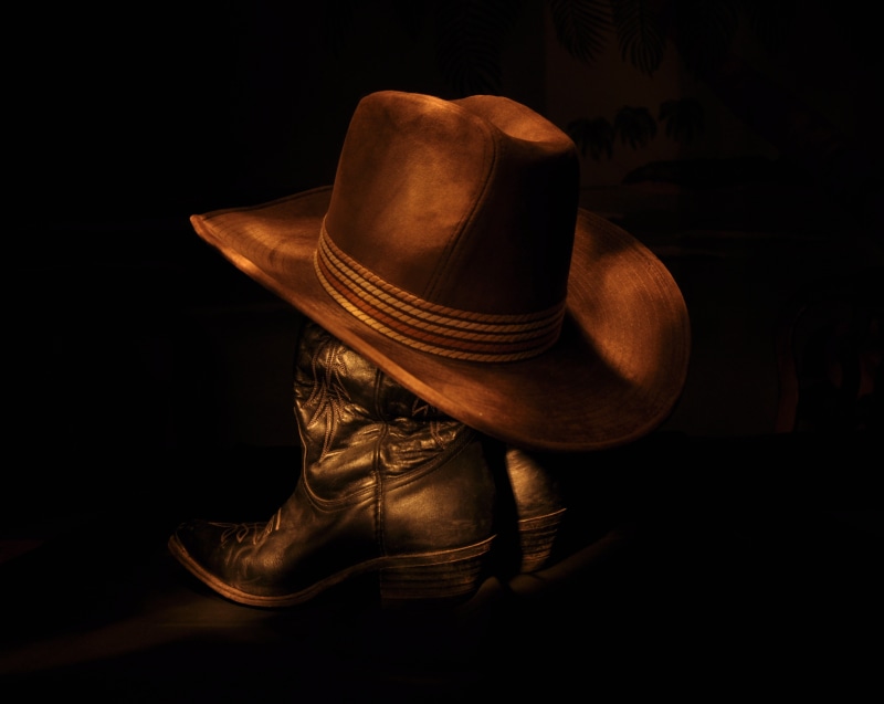 single object, boot, hat, wild West, cowboy, pair, light painting, 2K, leather, indoors, black, fashion, boots, headwear, no people, shoe, brown, studio shot