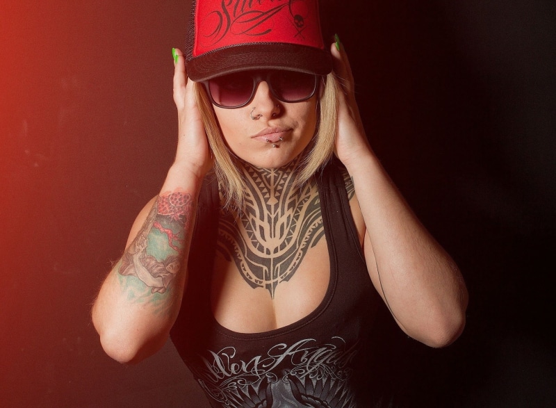 blonde, pierced lip, pierced nose, tank top, individuality, waist up, studio shot, hat, adult, Teya Salat, hairstyle, women, looking at camera, front view