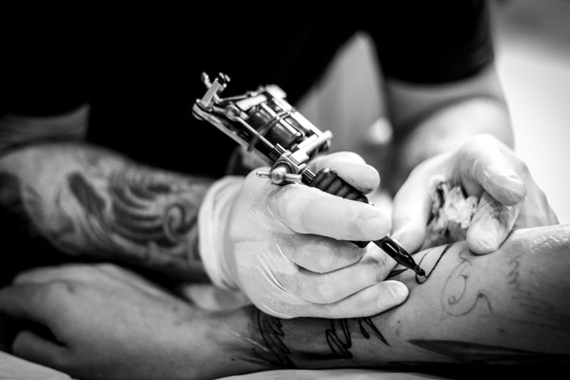 person, arm, painting, one, human body part, tattoo, women, holding, using, tattooing, skill, people, male, indoors, body adornment, occupation, protection