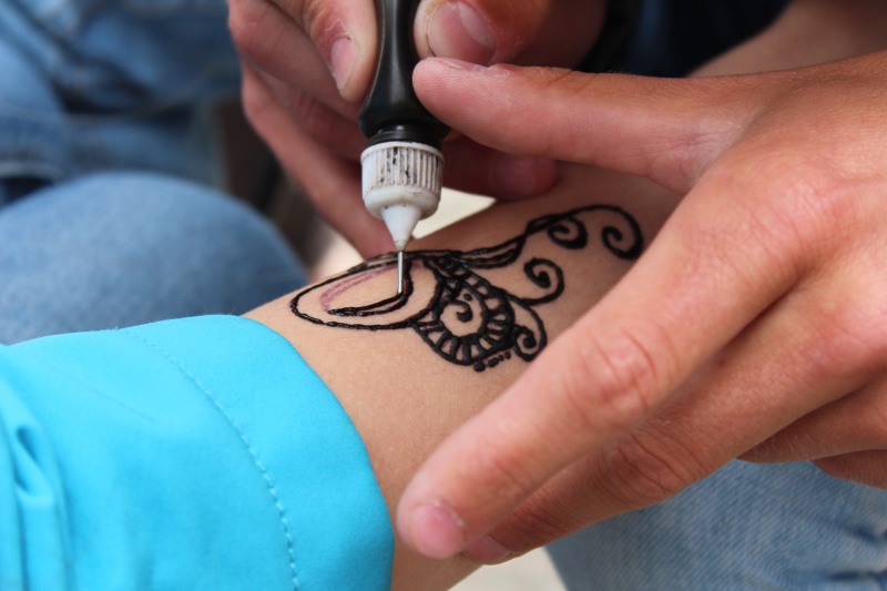 working, body adornment, Tattoo, body part, holding, person, arm, art and craft, hand, indoors, craft, doctor, men, adult, design, patient, henna, one person