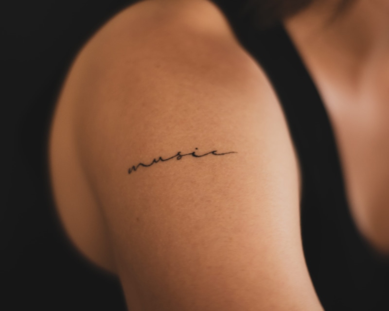 studio shot, human skin, music, black background, human limb, midsection, body adornment, body part, human leg, bicep, 4K, communication, one person, indoors