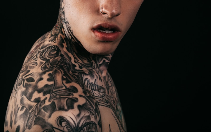 only women, body adornment, tattoo, human body part, black background, indoors, lips, body part, close-up, photography, adult, people, young adult, man