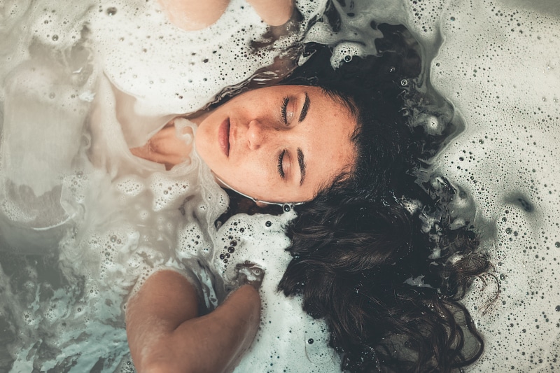 facial expression, beautiful woman, bathroom, person, soak, bubbles, soap sud, real people, wet, water, lifestyles, soaked, lady, females, bathtub, human