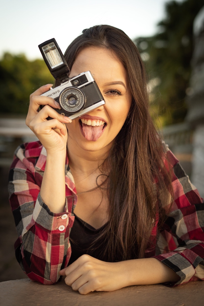 beauty, focus on foreground, woman, facial expression, outdoors, headshot, pretty, person, taking picture, equipment, posing, young woman, emotion, smiling