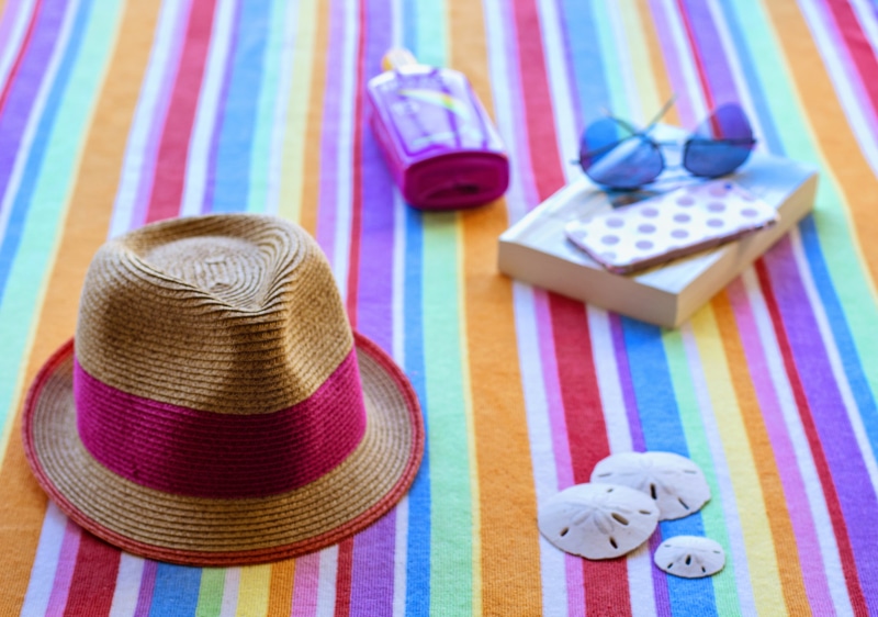 relaxation, sun, seaside, personal accessory, wood - material, pattern, tourism, shore, fun, pink, style, indoors, multi colored, sand, sky, leisure, beach