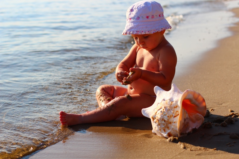 sand, water, small, shell, wearing, beach, happiness, cap, cute, females, caucasian Ethnicity, playing, happy, hat, land, childhood, young, beside, full length