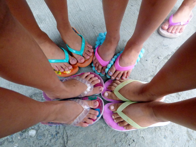 clothing, pink, foot, bonding, flops, barefoot, human limb, shoes, legs, flip flops, child, wearing, human leg, body part, rubber, human, shoe, nail, human foot