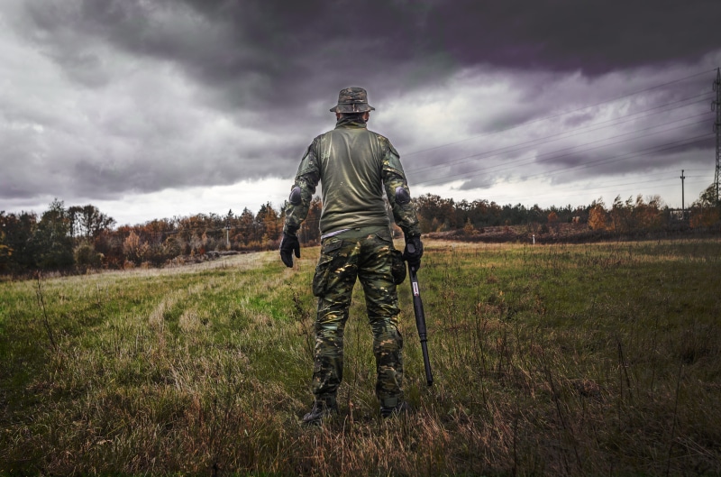 camouflage, combat, holding, m16, gun, adult, helmet, uniform, man, clothing, armed forces, cloud - sky, people, armed, solo, land, army, protection, nature